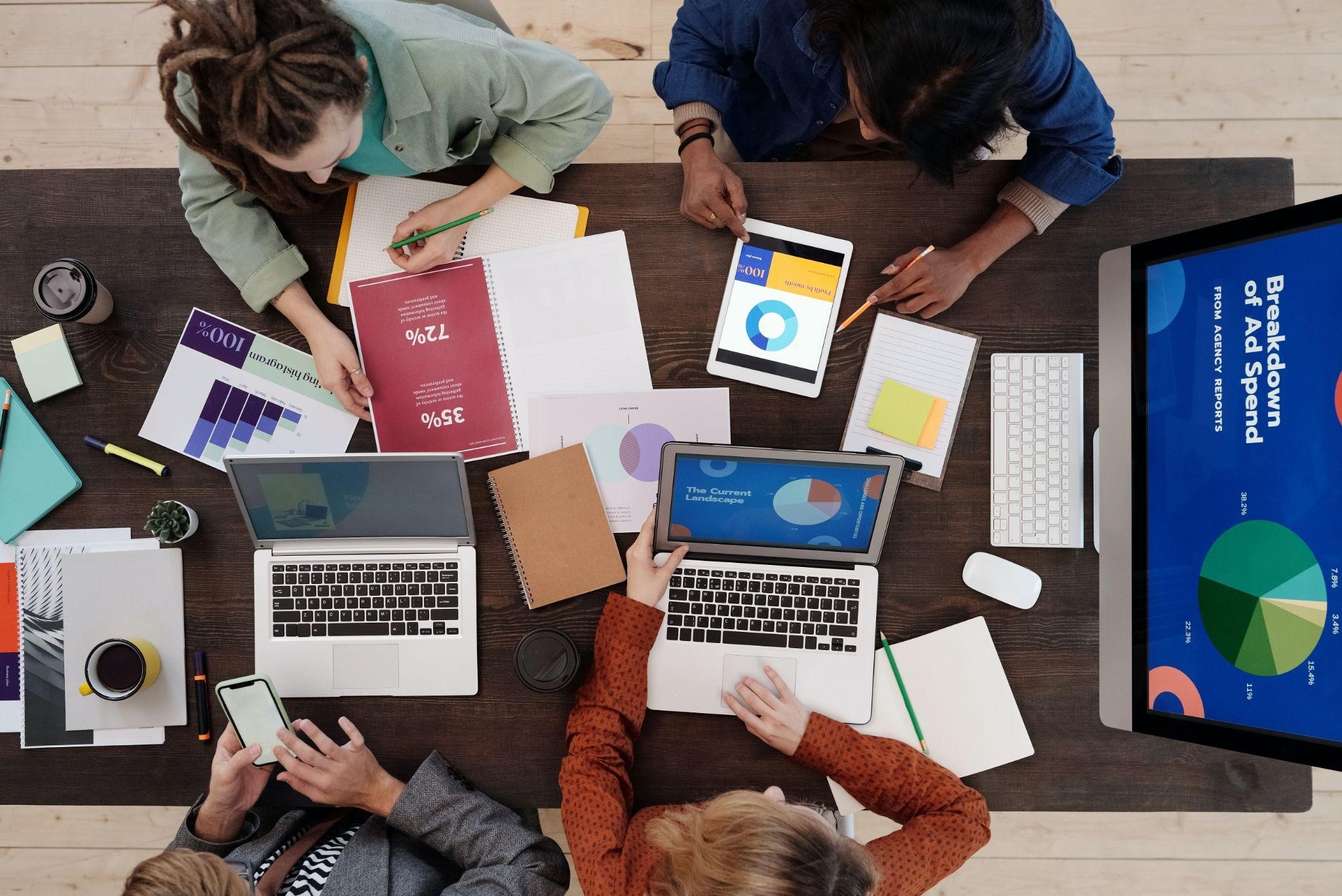 A group of marketers looking at various charts and metrics of customer satisfaction and